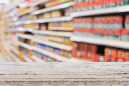 Empty table over blur supermarket with bokeh background, Product shelfの写真素材