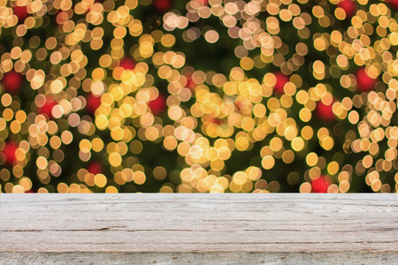 Christmas holiday background with empty wooden deck table over festive bokeh. Ready for product montageの写真素材