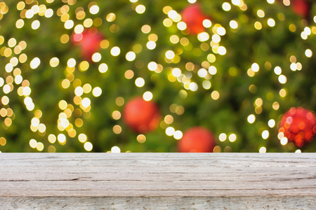 Christmas holiday background with empty wooden deck table over festive bokeh. Ready for product montageの写真素材