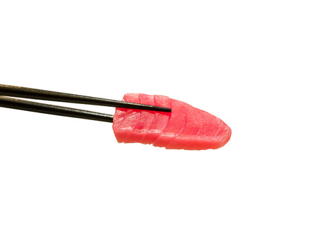 tuna sashimi in chopsticks isolated on white backgroundの写真素材