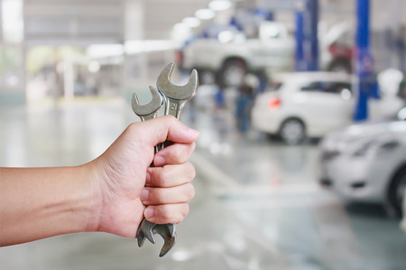 Hand of professional Auto mechanic with wrench, Auto repair serviceの写真素材