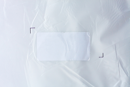 White sticker label on plastic background