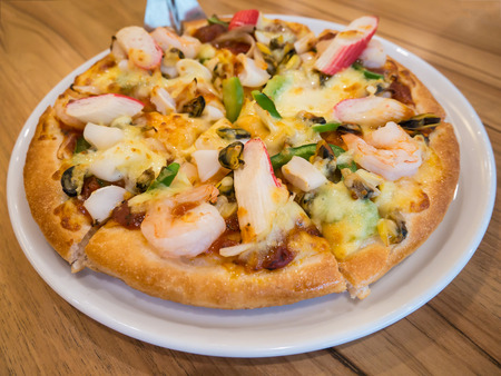 delicious pizza with seafood on wooden tableの写真素材