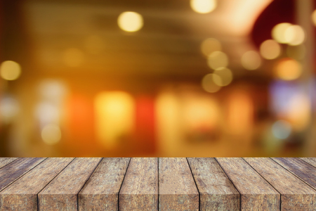 empty wood table top on Blur cafe restaurant with abstract bokeh light backgroundの写真素材