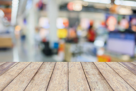wood table with eletronic department store with bokeh blurred backgroundの写真素材