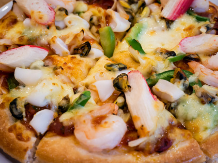 delicious pizza with seafood on wooden tableの写真素材