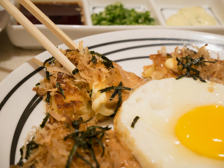 Japanese pizza, Japanese food okonomiyaki with eggの写真素材