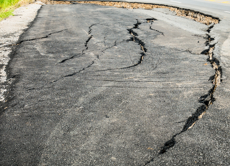 asphalt road cracked and broken textureの写真素材