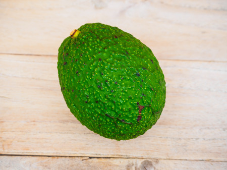 fresh organic avocado on wooden tableの写真素材