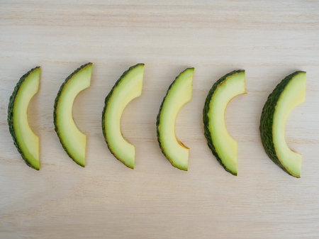 avocado slice on wood background