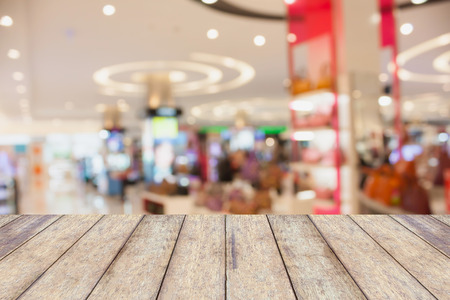wood counter product display with shopping mall store blur background with bokehの写真素材