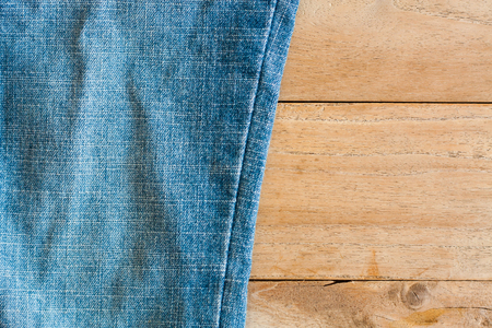 Close up of blue jeans ,Blue Jeans texture on wooden floorの写真素材