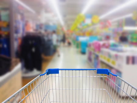 shopping cart with supermarket in blurry for backgroundの写真素材