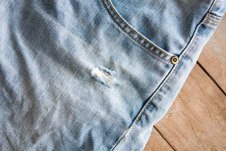 Close up of blue jeans ,Blue Jeans texture on wooden floorの写真素材