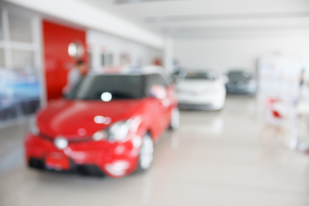 new car at new car showroom dealership blurred backgroundの写真素材