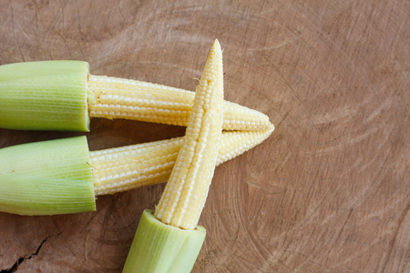 baby corn on wood backgroundの写真素材