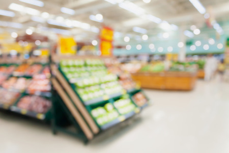 Fruits and vegetables on shelves in supermarket blur backgroundの写真素材