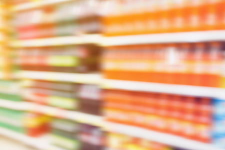 soft drink bottles on shelves in supermarket motion blur backgroundの写真素材
