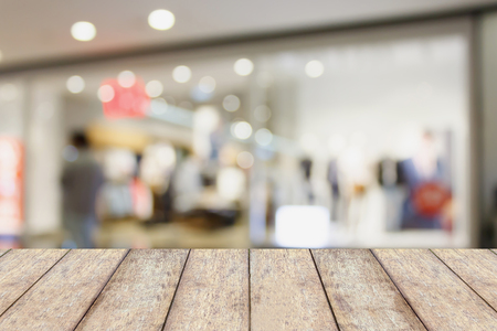 wood table with shopping mall store blurred background, product displayの写真素材