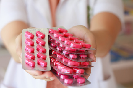 Close up of female doctor hands holding pillsの写真素材