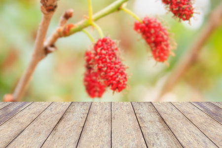 wood table with red mulberries background, product displayの写真素材