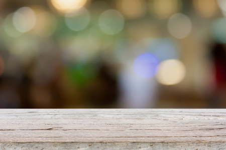 wood table with restaurant blur background with bokehの写真素材