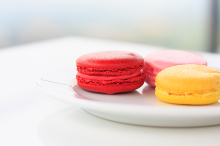 Sweet and colourful french macarons on white tableの写真素材
