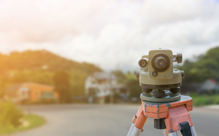 theodolite instrument for road construction surveyor equipment with road construction site works blur backgroundの写真素材