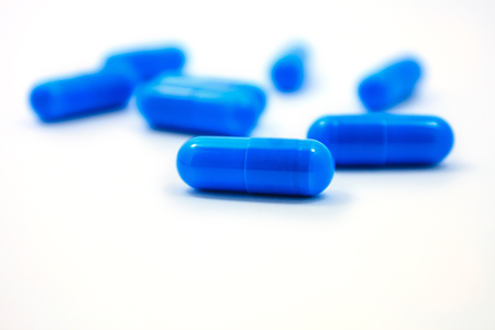 blue capsules isolated on a white backgroundの写真素材