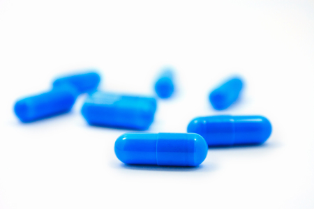 blue capsules isolated on a white backgroundの写真素材