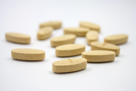 nutritional vitamin supplement pills on white backgroundの写真素材
