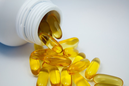 Fish oil capsules and containerの写真素材