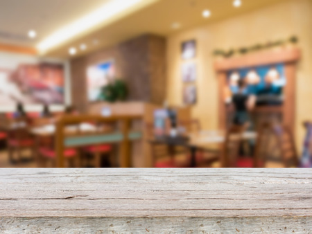 wooden table with blur restaurant, vintage style photoの写真素材