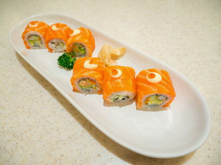 Sushi rolls with salmon on white plateの写真素材
