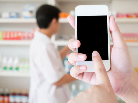 women using smart phone in pharmacy blurred background, Pharmacist, Clinic, Pharmacy, Phone, Hand, Hospitalの写真素材