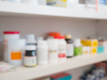 Close up of medicine bottles on shelves of drugs in the pharmacy store blur backgroundの写真素材