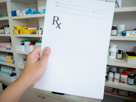 Pharmacist holding prescription in the pharmacyの写真素材