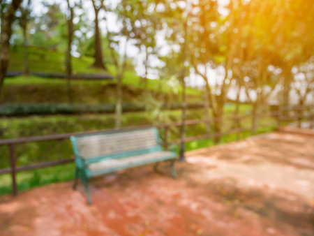 blur bench in the park summer time natural backgroundの写真素材