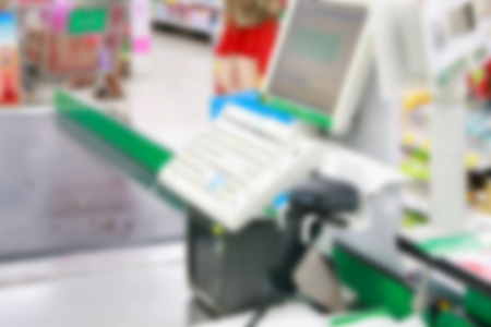 Empty cash desk with payment terminal blurred backgroundの写真素材