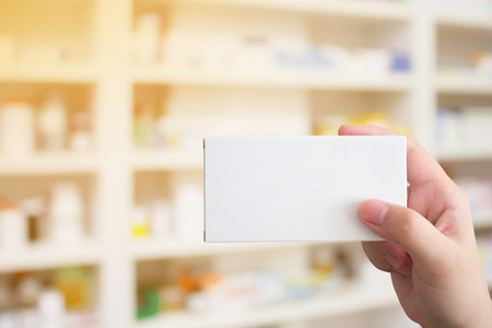 hand hold medicine package over the pharmacyの写真素材