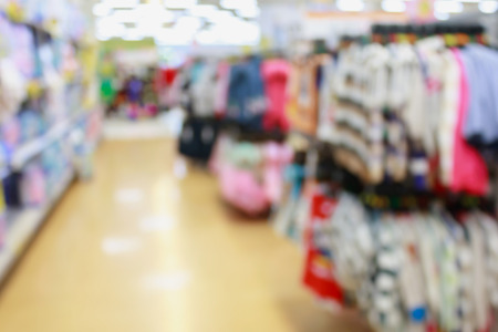 Kids sweaters on stands in supermarket blurred backgroundの写真素材