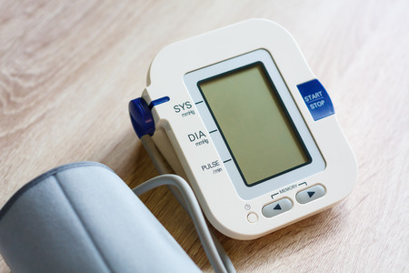 Digital Blood Pressure Monitor on wood tableの写真素材