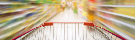 Supermarket interior, supermarket aisle with empty red shopping cart motion blur effect, shopping in supermarket conceptの写真素材