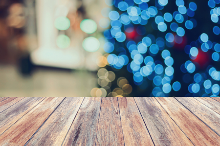Christmas holiday background with empty wooden table top over festive bokeh light decorate on Christmas tree. For create montage product displayの写真素材