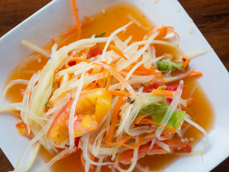 Thai papaya salad (Som tum Thai) on wood tableの写真素材