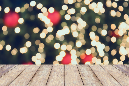Christmas holiday background with empty wooden table top over festive bokeh light decorate on Christmas tree. For create montage product displayの写真素材