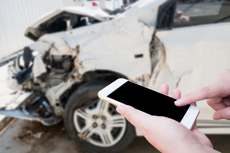 Female using mobile smart phone taking photo of the car crash accident damage for insurance