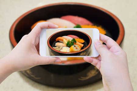 Taking photo of Sushi Setの写真素材