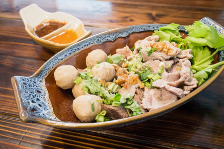 Thai food, meat balls and beef with spicy sauce on wood tableの写真素材