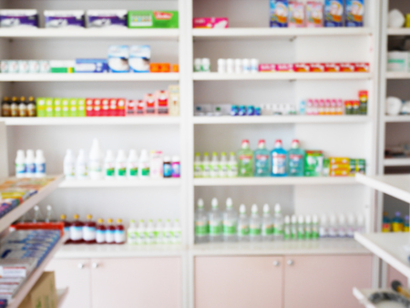 pharmacy store with blur medicines arranged on shelvesの写真素材
